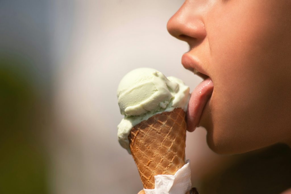 Aphrodisiac photo of a girl licking ice-cream probably with tiger nut powder